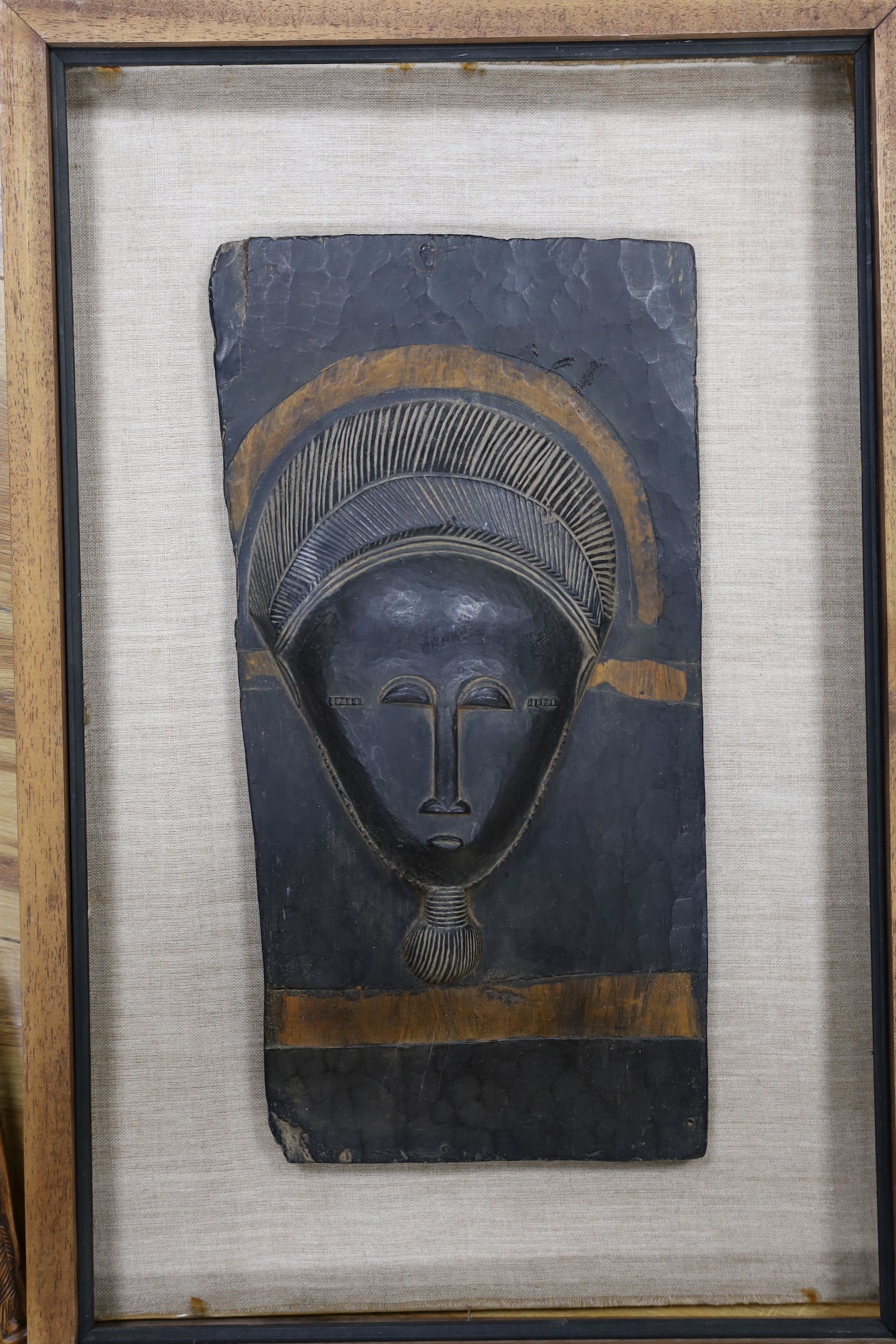An African framed tribal mask and a carved stick